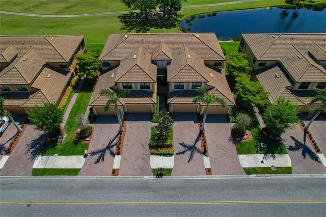 an aerial view of lake and residential houses with outdoor space