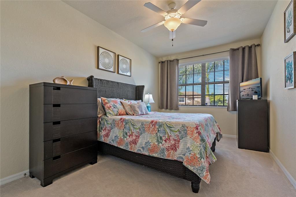 7015 Grand Estuary Trail, Unit 103 Bradenton, FL 34212 - Photo 21 of 62 a bedroom with a bed dresser and a window
