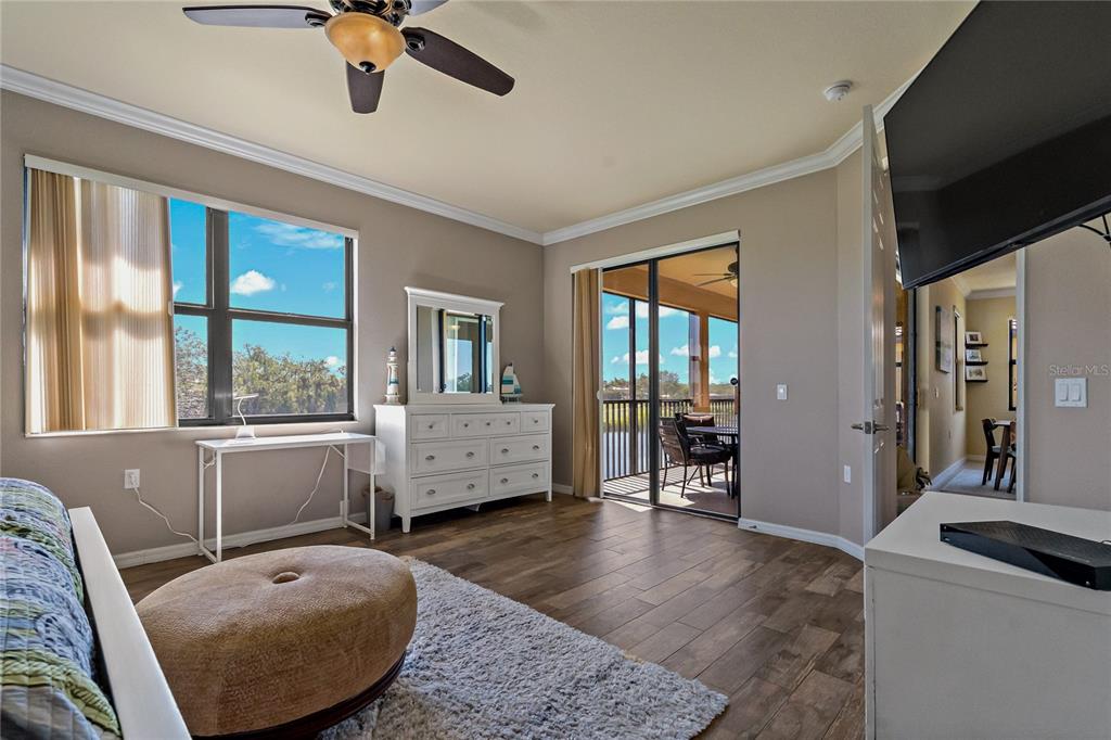 7015 Grand Estuary Trail, Unit 103 Bradenton, FL 34212 - Photo 32 of 62 a living room with furniture and large windows