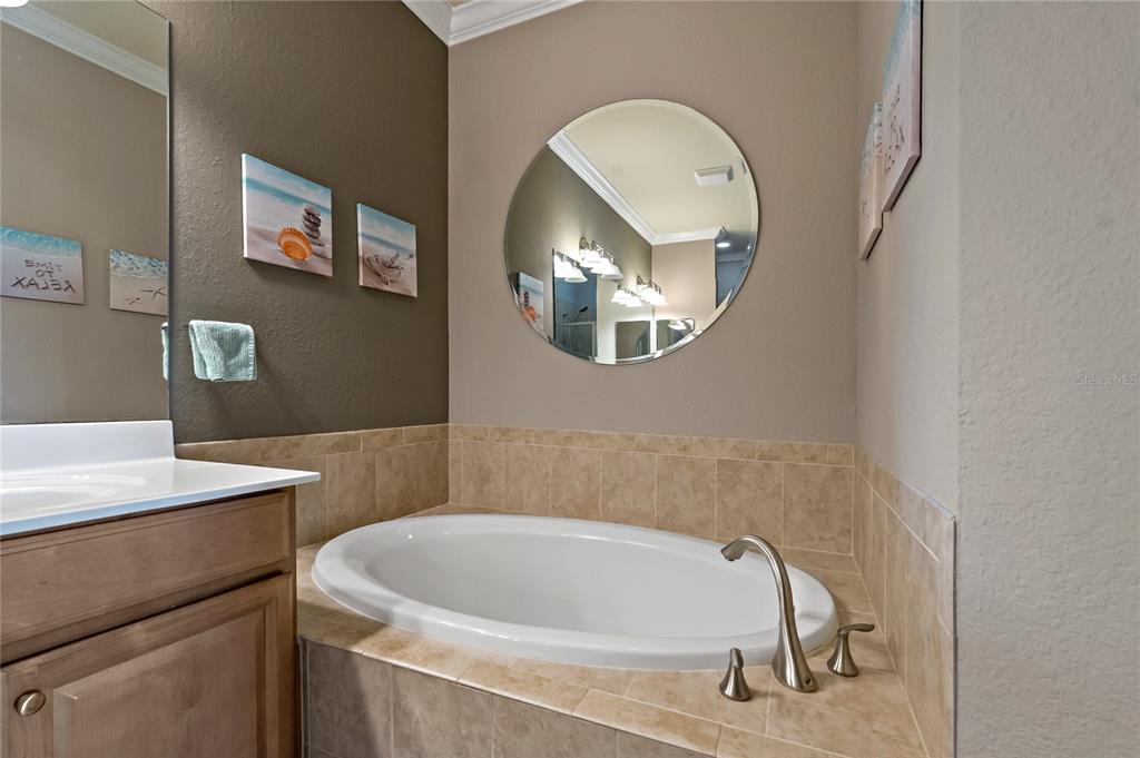 7015 Grand Estuary Trail, Unit 103 Bradenton, FL 34212 - Photo 34 of 62 a bathroom with a sink and a mirror