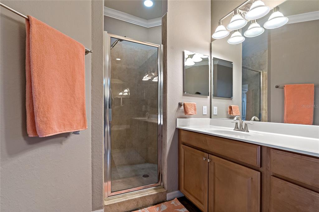 7015 Grand Estuary Trail, Unit 103 Bradenton, FL 34212 - Photo 35 of 62 a bathroom with a mirror sink and vanity
