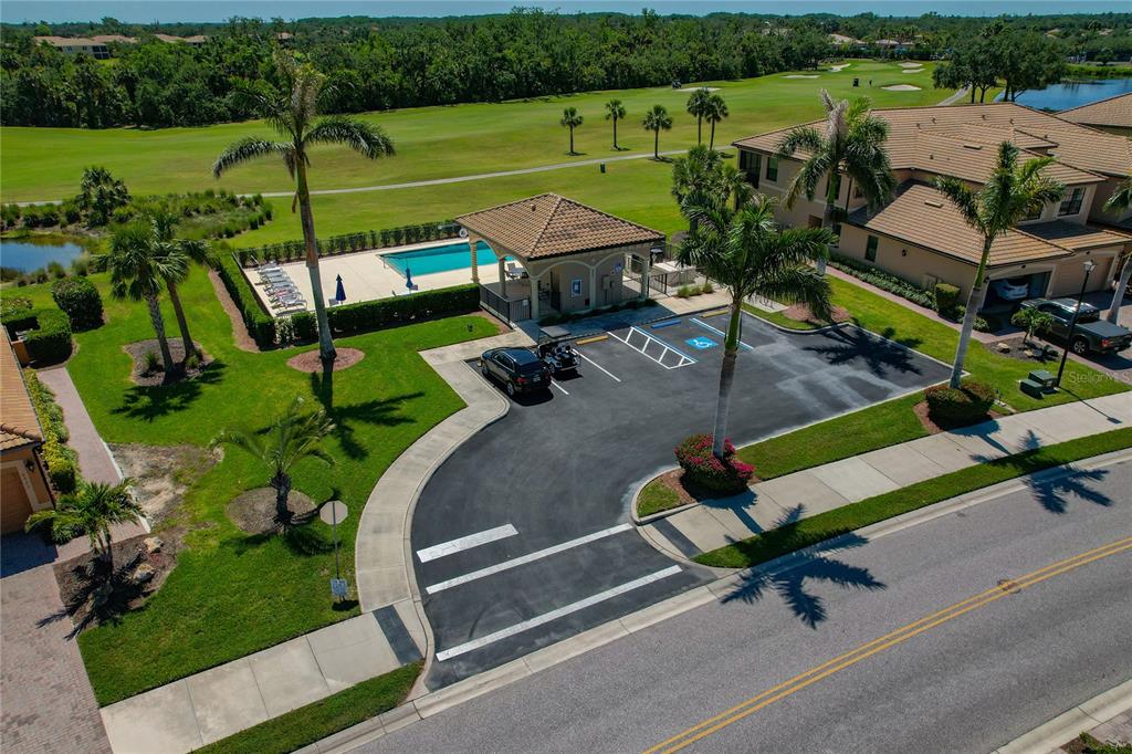 7015 Grand Estuary Trail, Unit 103 Bradenton, FL 34212 - Photo 47 of 62 an aerial view of a backyard with swimming pool and green space