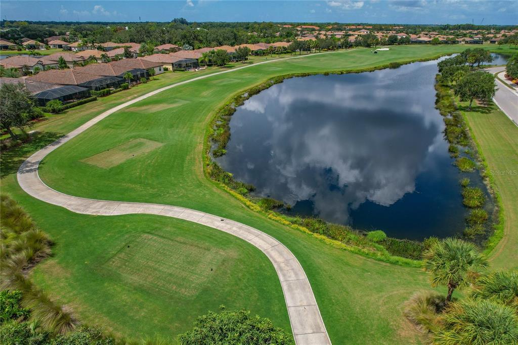 7015 Grand Estuary Trail, Unit 103 Bradenton, FL 34212 - Photo 49 of 62 an aerial view of a golf course with a park