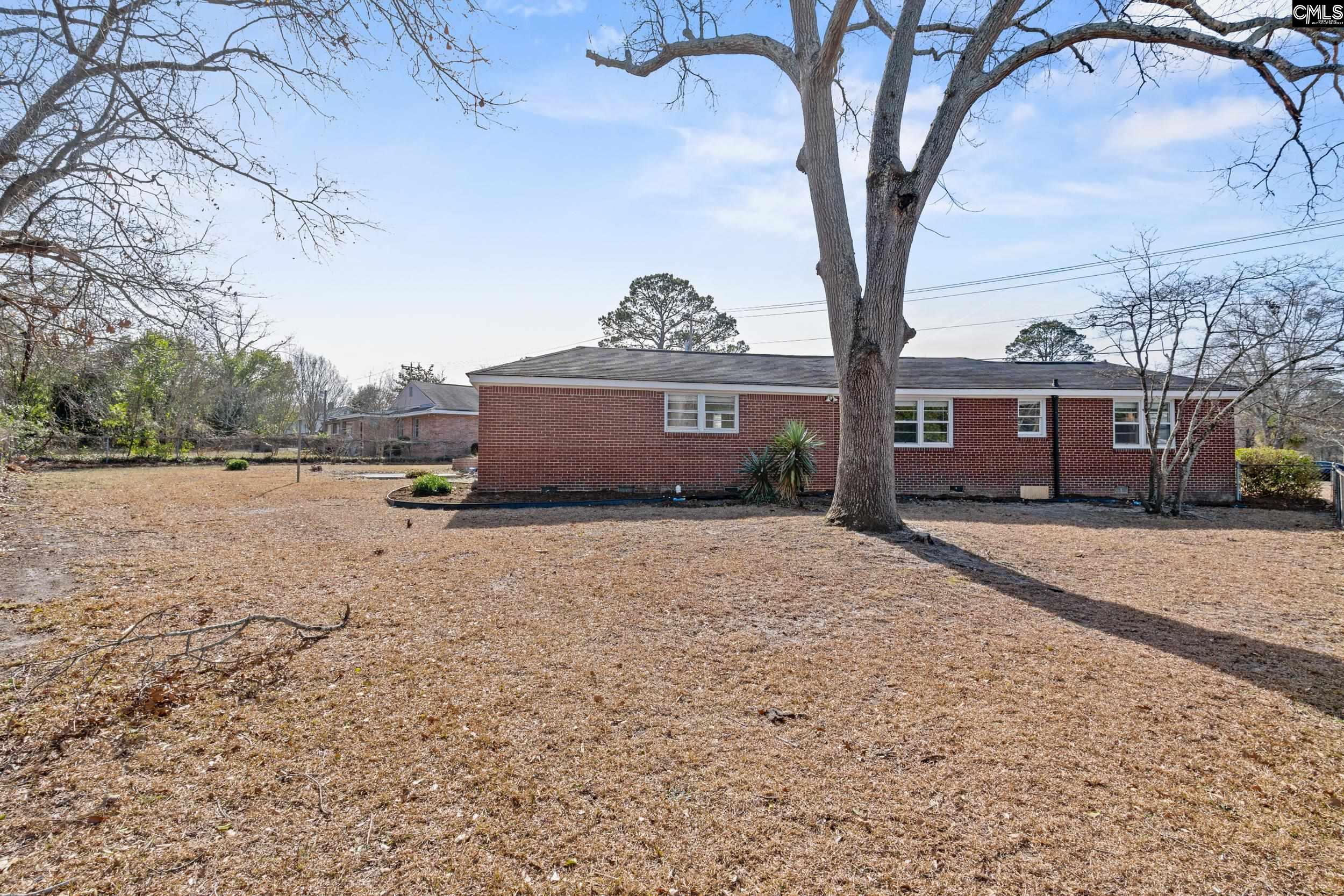 409 Wilkes Road Columbia, SC 29203 - Photo 33 of 34 a front view of a house with a yard