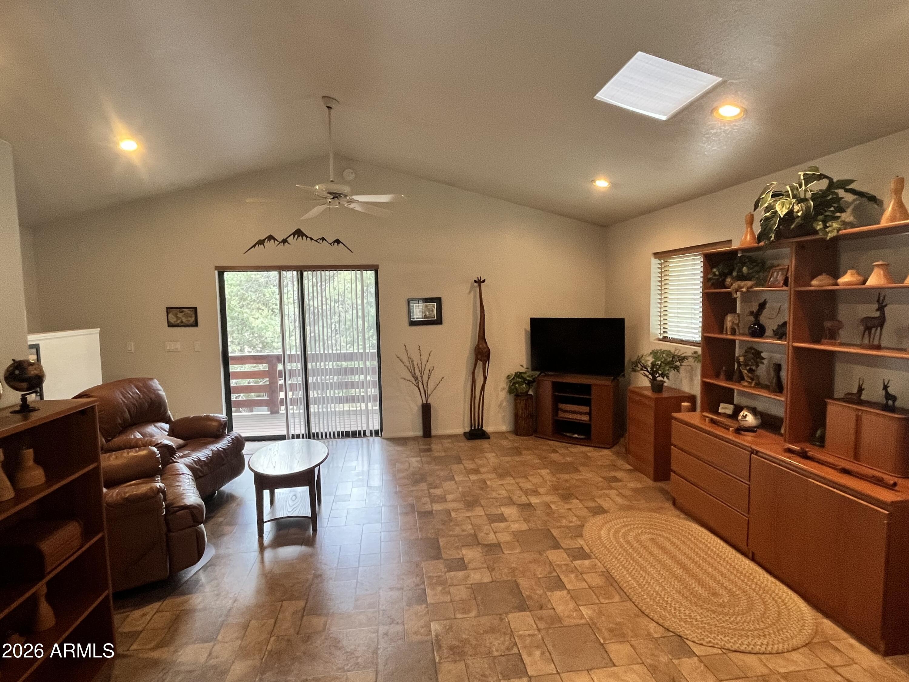 1006 North Matterhorn Road Payson, AZ 85541 - Photo 24 of 37 a living room with furniture a flat screen tv and a fireplace