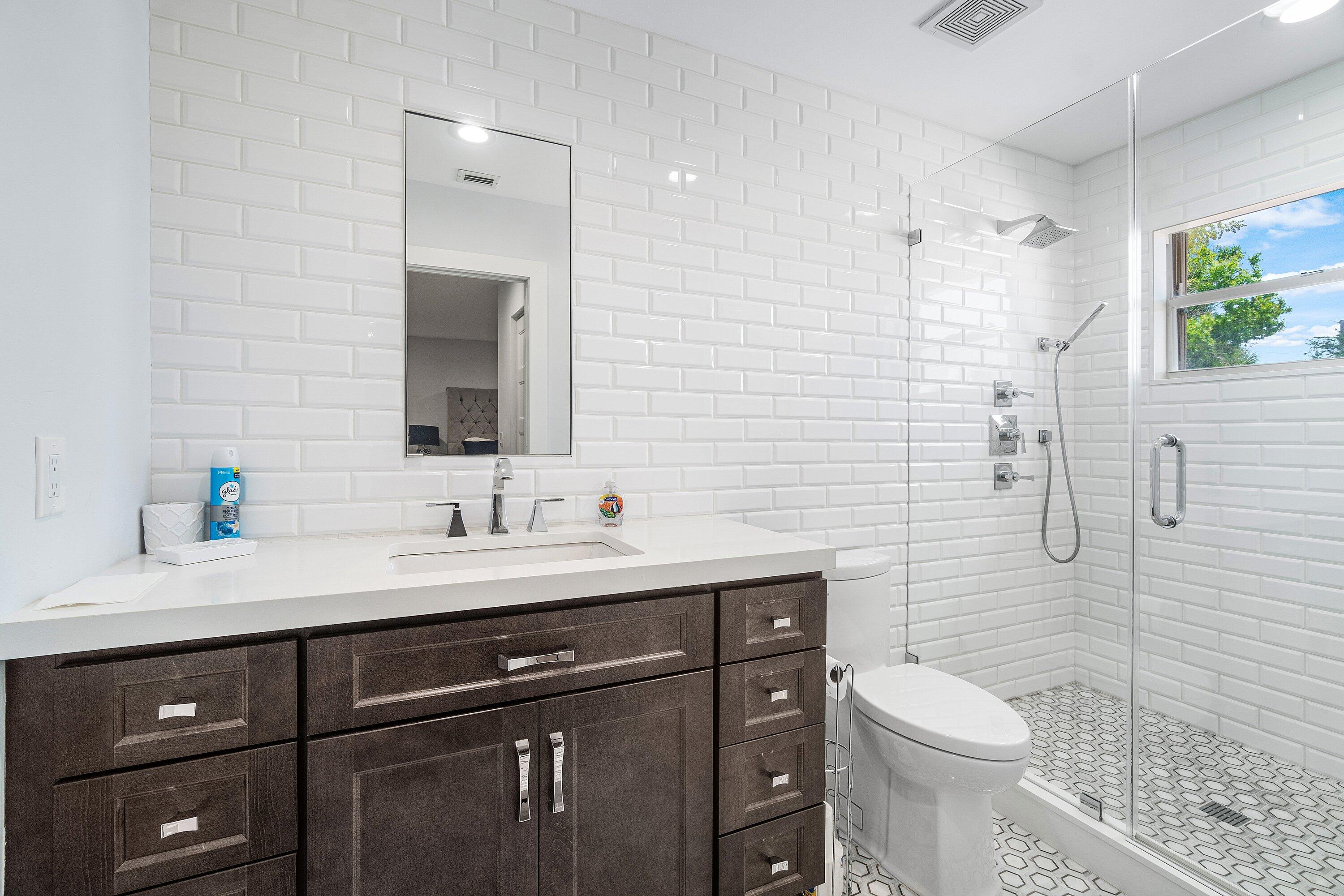 2404 Northwest 67th Street Boca Raton, FL 33496 - Photo 34 of 74 a bathroom with a sink a toilet and shower