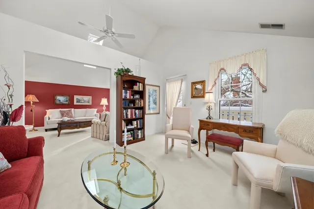 a living room with furniture a chandelier and a flat screen tv