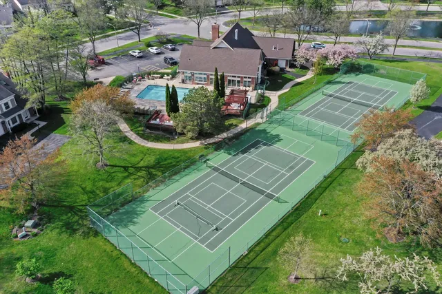 an aerial view of residential houses with outdoor space and street view
