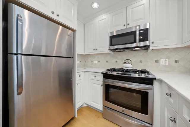 a kitchen with a stove microwave and refrigerator