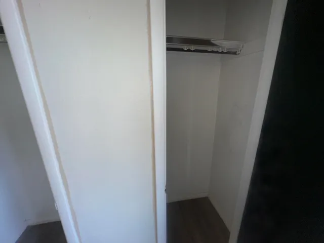 a view of a hallway with wooden floor and stairs