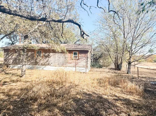 a backyard of a house with a yard and garage