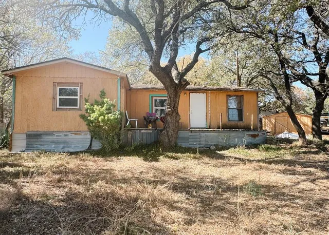 a view of a yard with trees