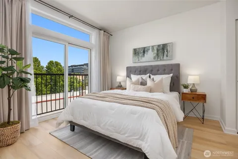 a bedroom with a bed and a large window