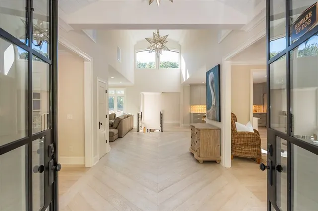 a living room with furniture a window and a chandelier