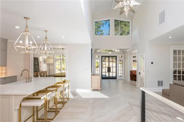 a living room with furniture and a chandelier