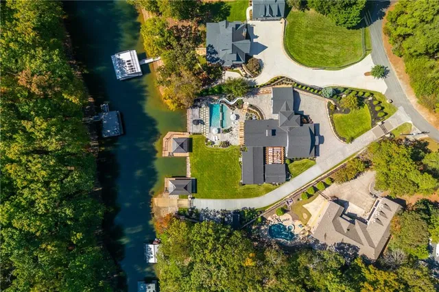 a living room with furniture flat screen tv and a large window
