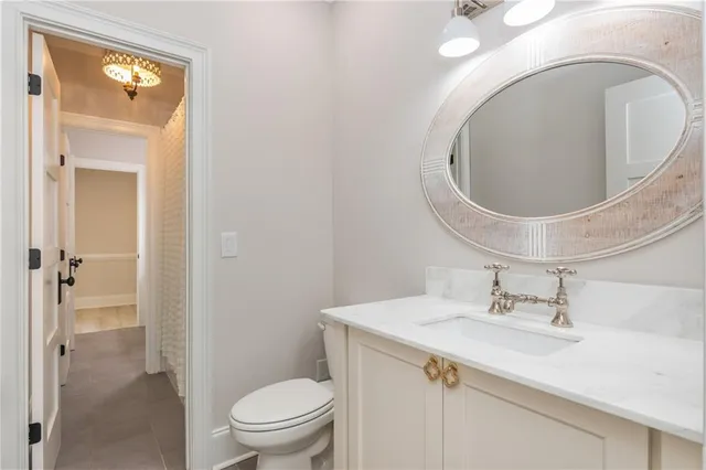 a spacious bedroom with a bed a table and a large mirror