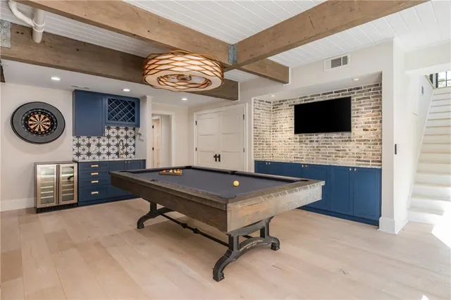 a spacious bedroom with a bed and a flat screen tv