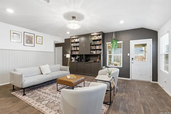 a living room with furniture and wooden floor
