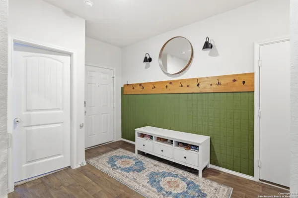 a living room with furniture kitchen view and a large window