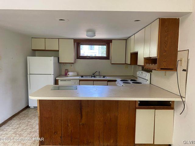 1045 Hampstead Road Bushkill, PA 18324 - Photo 3 of 14 a kitchen with a sink a refrigerator and a stove