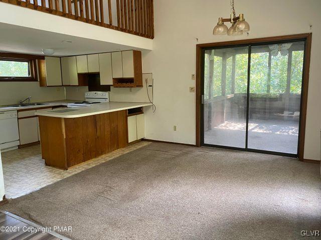 1045 Hampstead Road Bushkill, PA 18324 - Photo 4 of 14 a large kitchen with stainless steel appliances granite countertop a stove a sink and a refrigerator