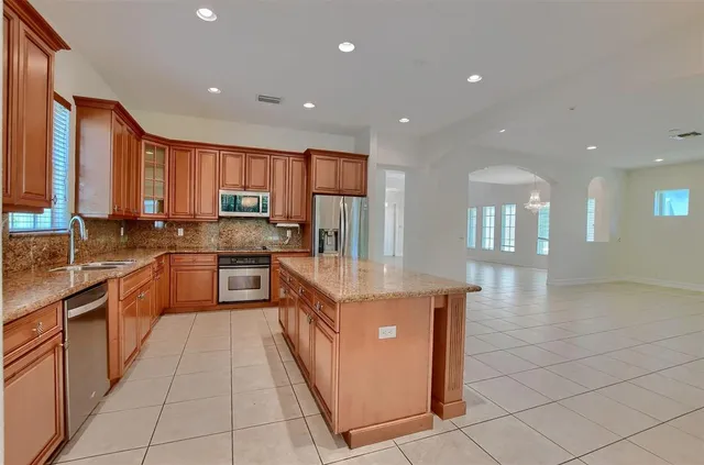 an empty room with a window and ceiling fan
