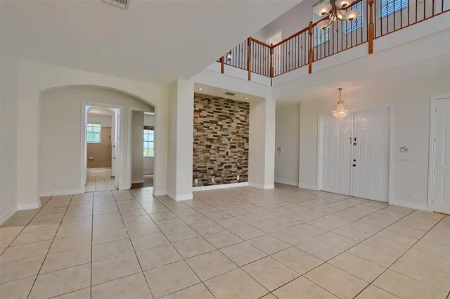a view of an empty room and staircase