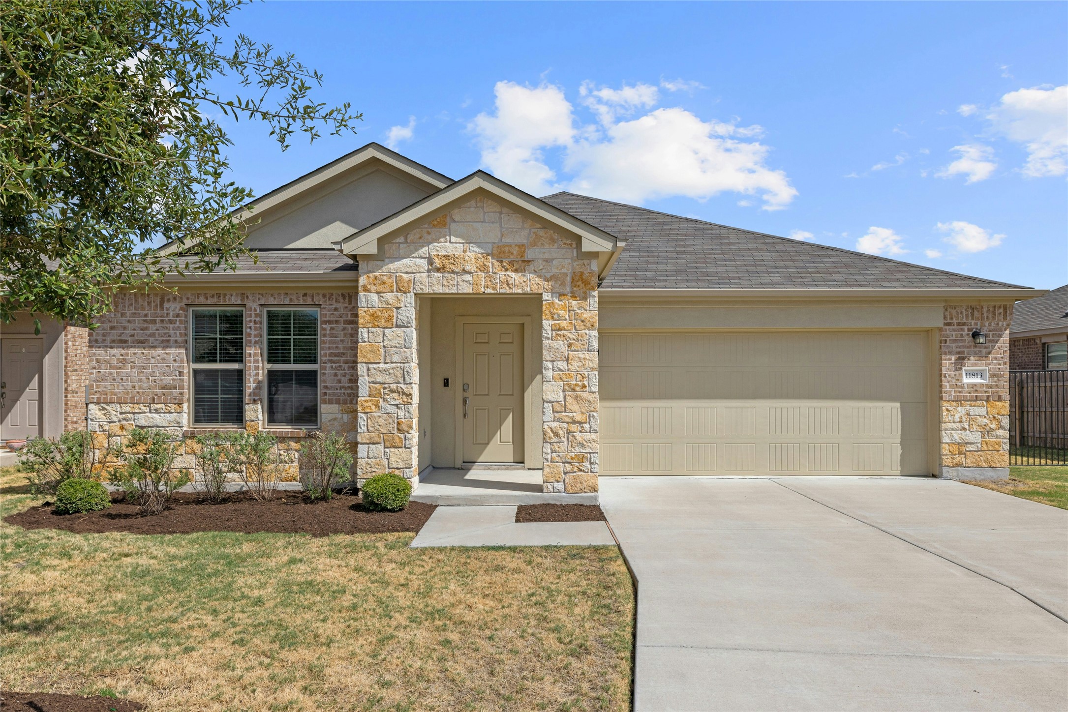 11813 Roscommon Trail Austin, TX 78754 - Photo 1 of 28 a front view of a house with garden