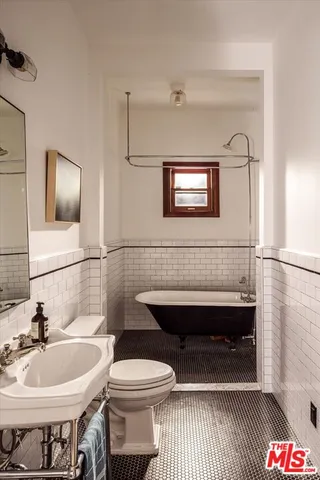 a view of a hallway with wooden floor and stairs