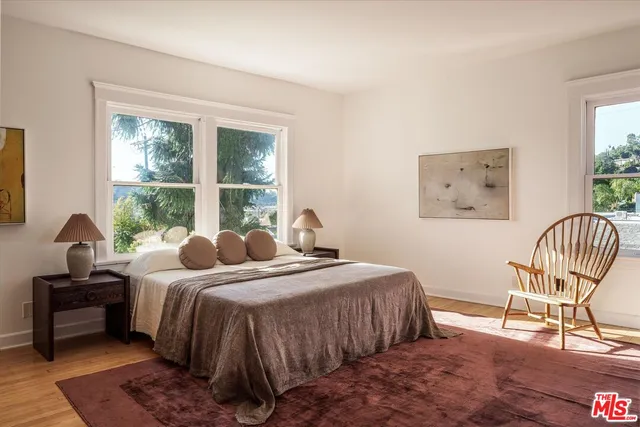 a bedroom with bed and a window