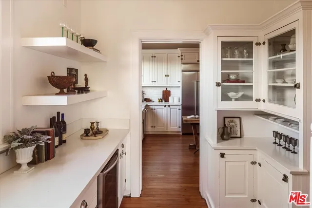 a kitchen with cabinets and wooden floor