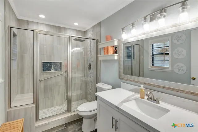 a bathroom with a sink toilet and shower