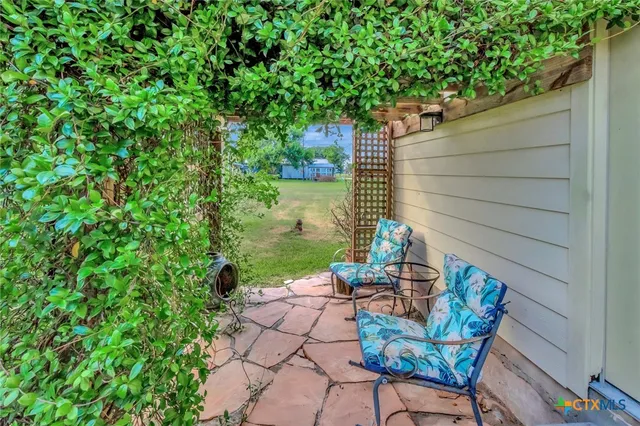 a view of a house with a small yard and floor to ceiling window