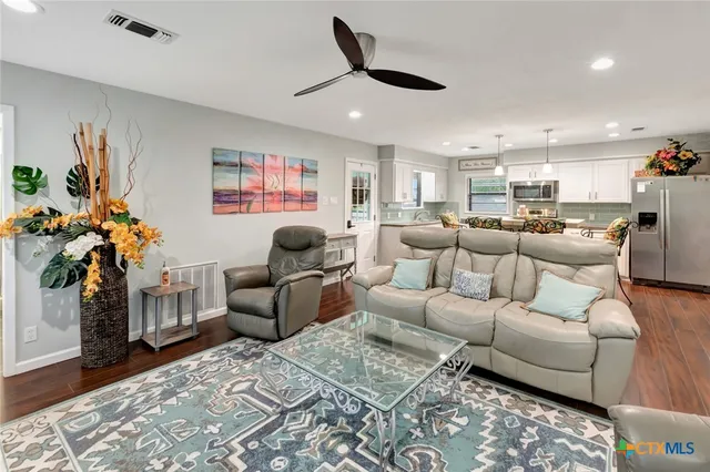 a living room with furniture and a potted plant