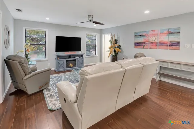 a living room with furniture and a flat screen tv