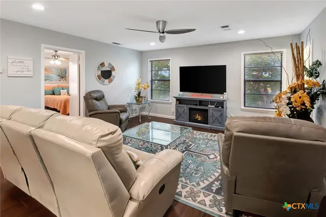 a living room with furniture and a flat screen tv