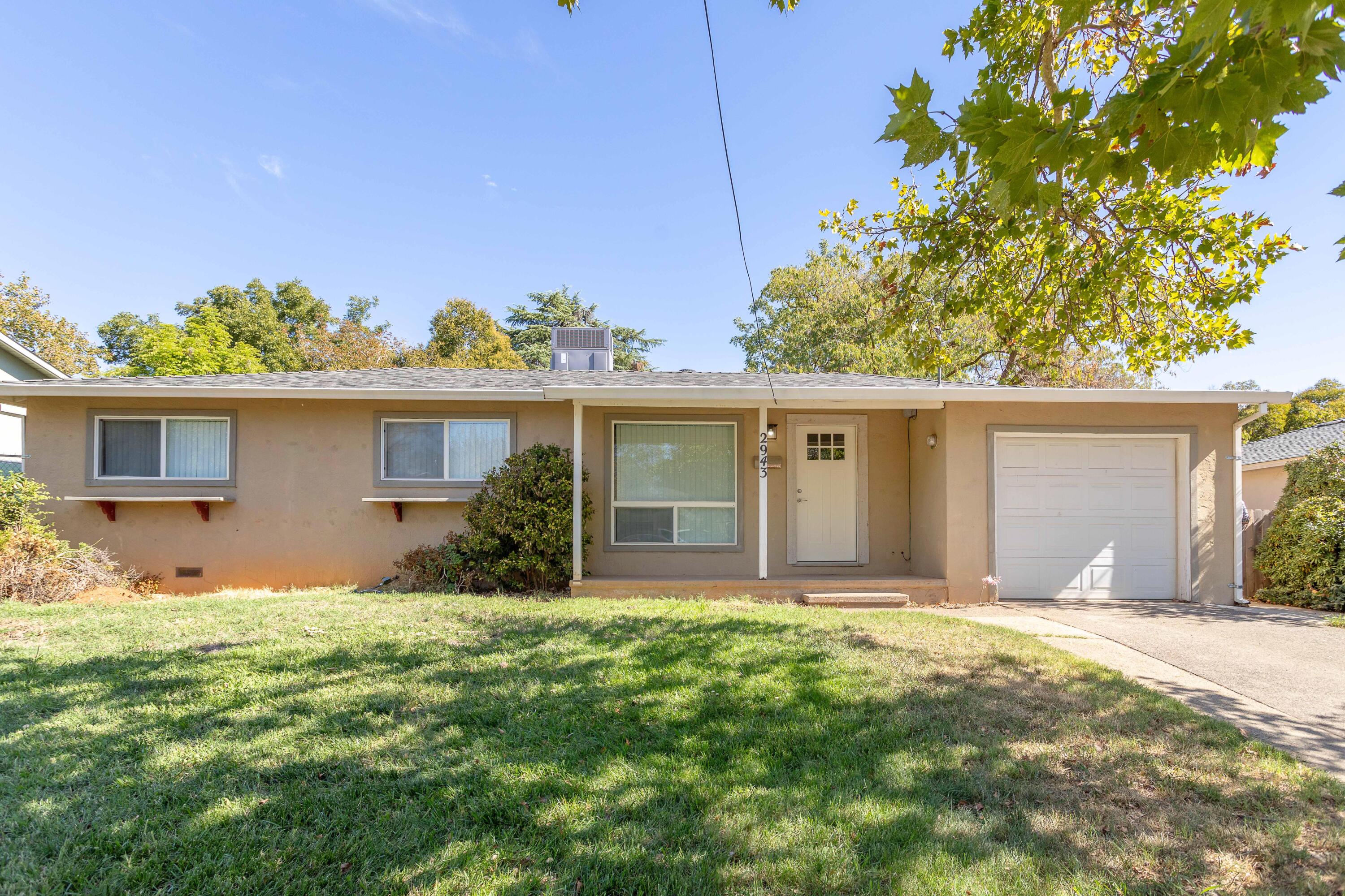a front view of a house with a garden and yard