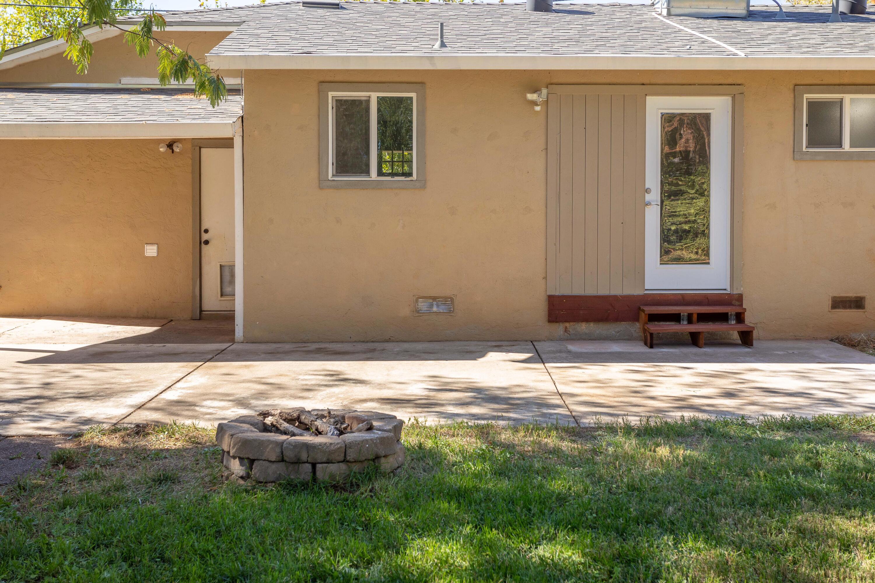 2943 Kenco Avenue Redding, CA 96002 - Photo 13 of 19 a backyard of a house with yard and seating space