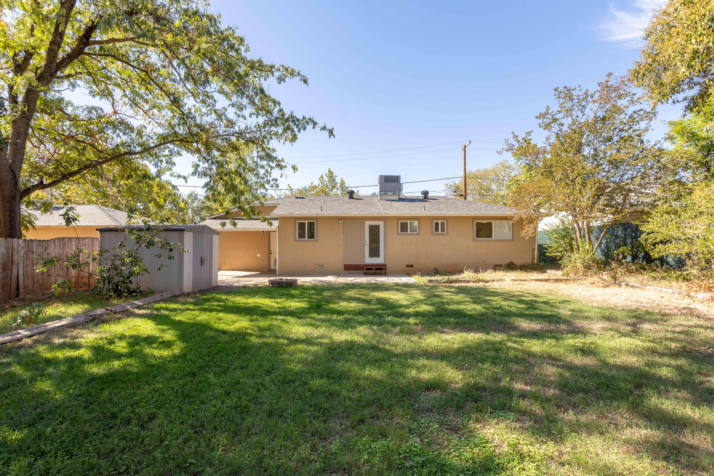 2943 Kenco Avenue Redding, CA 96002 - Photo 14 of 19 a view of a backyard with a garden
