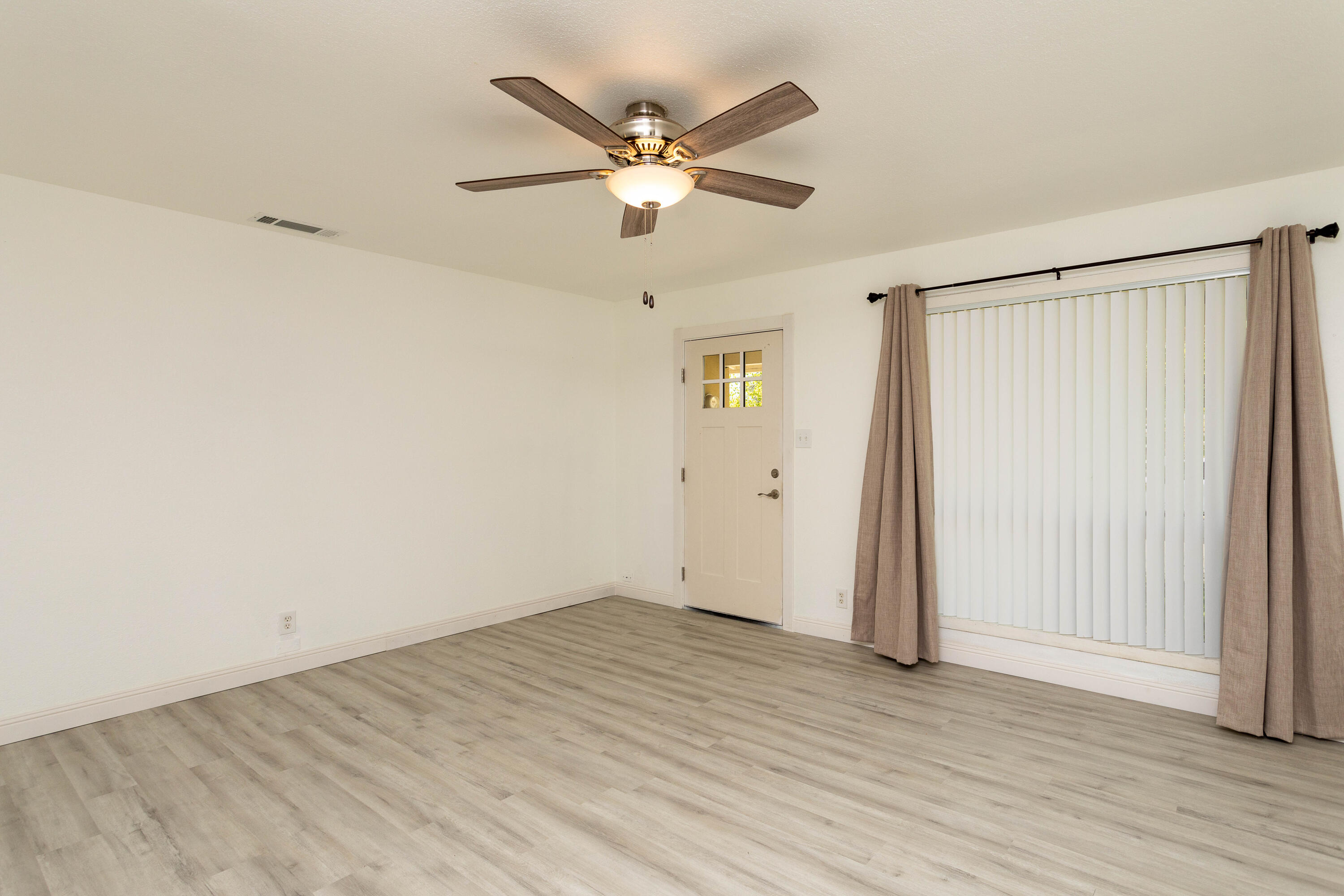 2943 Kenco Avenue Redding, CA 96002 - Photo 6 of 19 an empty room with wooden floor and ceiling fan