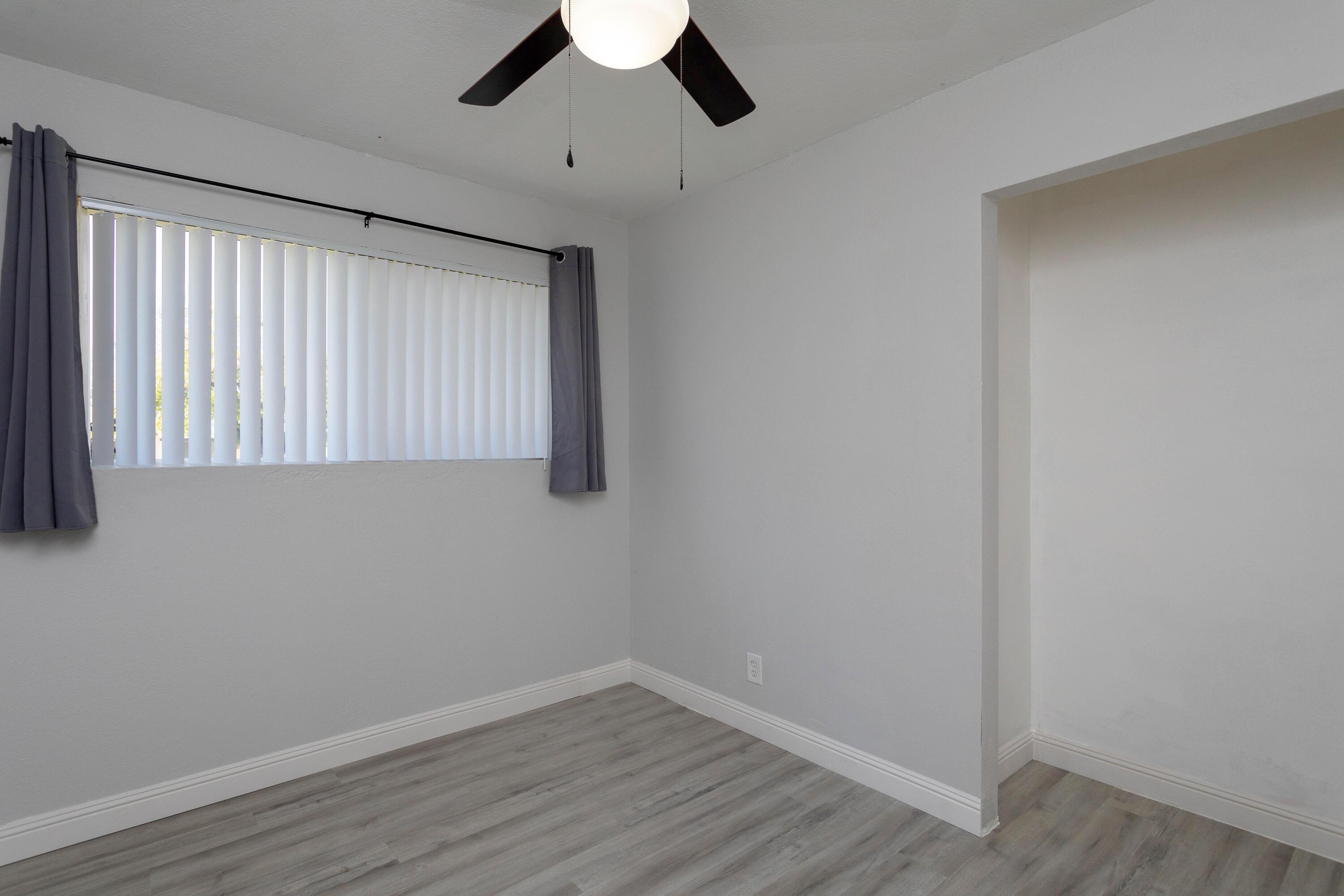 2943 Kenco Avenue Redding, CA 96002 - Photo 8 of 19 a view of an empty room with wooden floor and a window