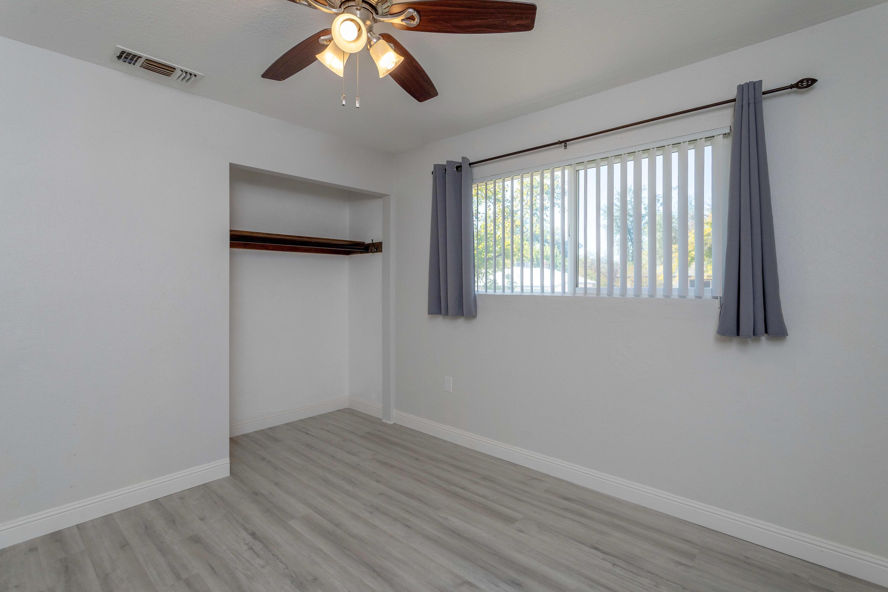 2943 Kenco Avenue Redding, CA 96002 - Photo 9 of 19 a view of an empty room with wooden floor and a window