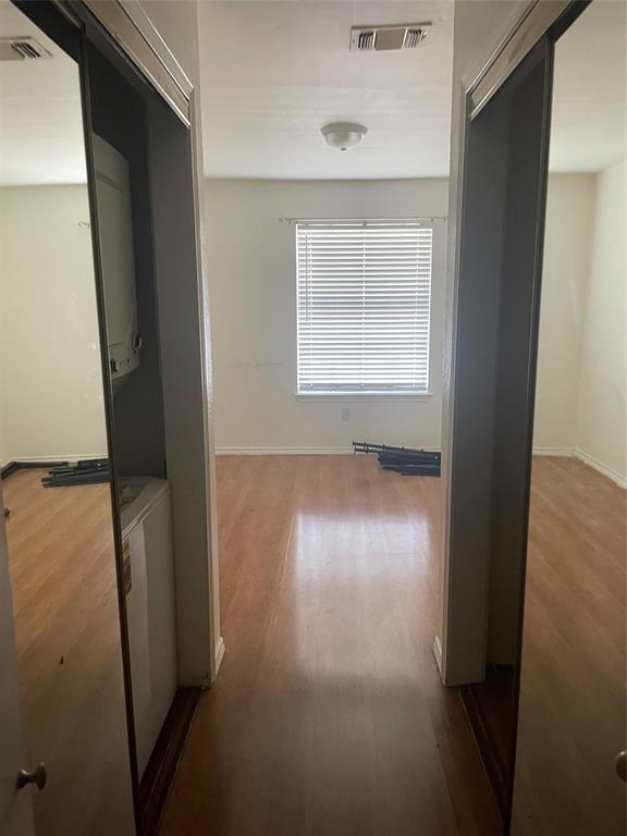 6108 Abrams Road, Unit 613 Dallas, TX 75231 - Photo 16 of 27 an empty room with wooden floor and windows