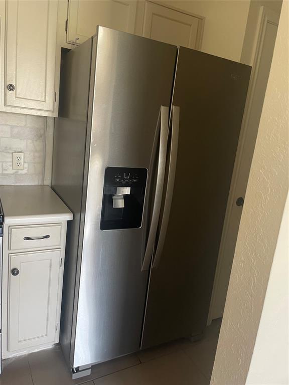 6108 Abrams Road, Unit 613 Dallas, TX 75231 - Photo 18 of 27 a view of a refrigerator and an empty room