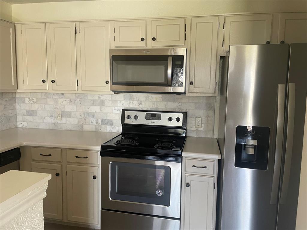 6108 Abrams Road, Unit 613 Dallas, TX 75231 - Photo 2 of 27 a kitchen with stainless steel appliances white cabinets and a stove