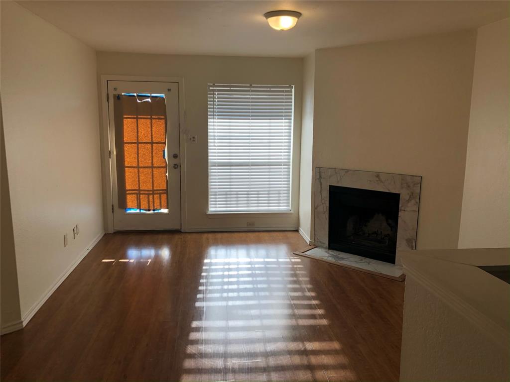 6108 Abrams Road, Unit 613 Dallas, TX 75231 - Photo 22 of 27 a view of an empty room with window and fireplace