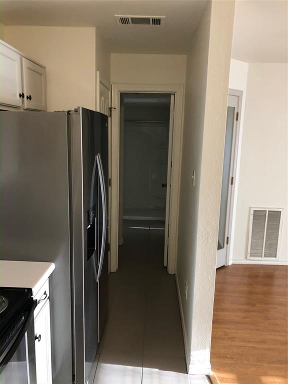 6108 Abrams Road, Unit 613 Dallas, TX 75231 - Photo 23 of 27 a view of a kitchen from the hallway