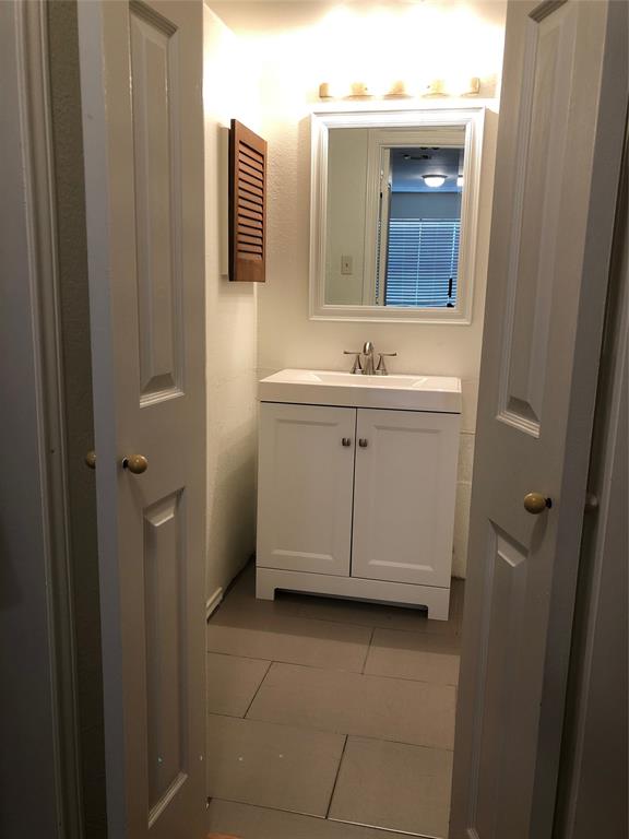 6108 Abrams Road, Unit 613 Dallas, TX 75231 - Photo 25 of 27 a bathroom with a sink and a mirror