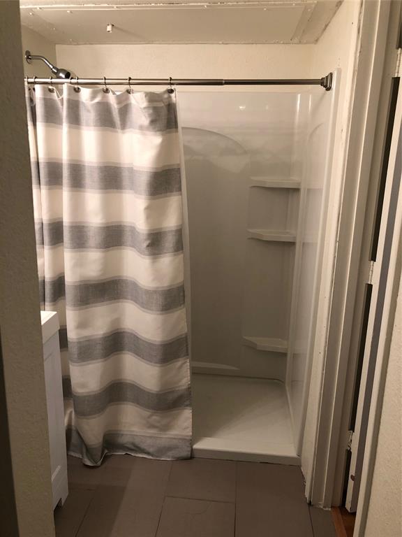 6108 Abrams Road, Unit 613 Dallas, TX 75231 - Photo 26 of 27 a bathroom with a glass door shower